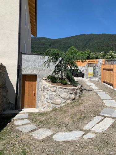 a stone walkway with a tree in front of a building at Castell Matscher in Bressanone