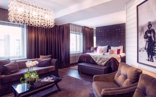 a living room with a bed and a couch at Arctic Light Hotel in Rovaniemi