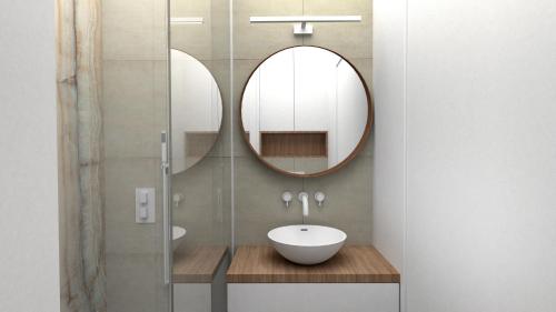 W łazience znajduje się umywalka i lustro. w obiekcie Apartament przy Krupowkach w Zakopanem