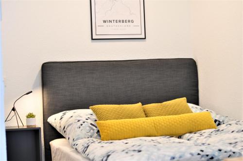 a bed with two yellow pillows on top of it at Loft Luis - Bikepark & Skilift - in Winterberg