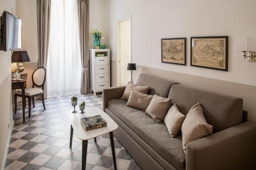 a living room with a couch and a table at Hotel Lido in Alassio