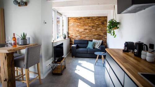 a kitchen and living room with a couch and a table at B&B Joeys place in Egmond aan Zee