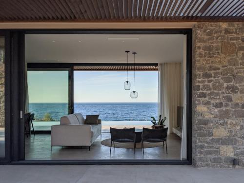 a living room with a view of the ocean at Nuez Villas in Mochlos