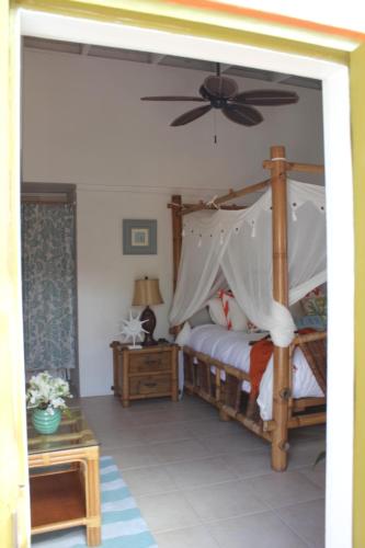 a bedroom with a bed with a ceiling fan at The Mafolie Hotel in Mafolie