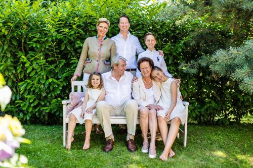 a family posing for a picture on a bench at Kurhotel Markushof in Bad Bellingen