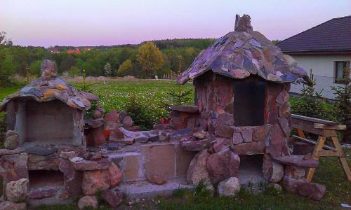 a garden with a play house and a bench at Pasja in Kwidzyn