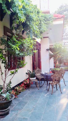 a patio with chairs and a table in a building at Air Star Hotel in Ho Chi Minh City