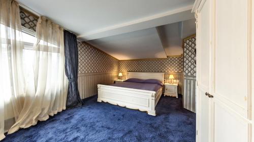 a bedroom with a bed and a blue carpet at Hotel Boyana - Free Parking in Sofia