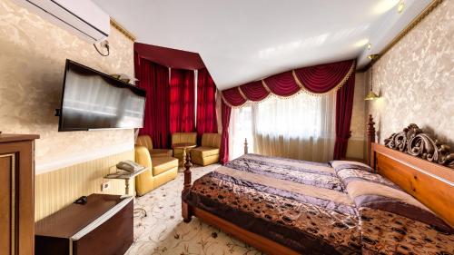 a hotel room with a bed and a television at Hotel Sveti Nikola Boyana - Free Parking in Sofia