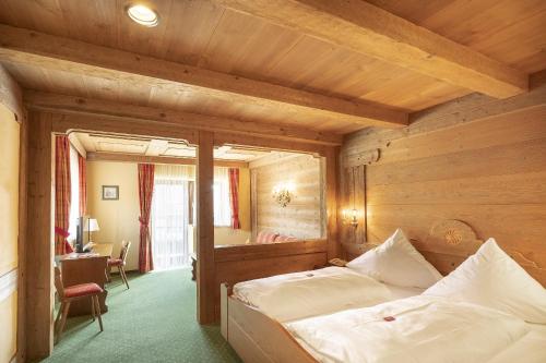 a bedroom with two beds in a wooden room at Landgasthof Zur Post in Schleching