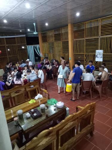 a group of people standing in a room with tables at Hoa Lan Hotel in Bak Kan