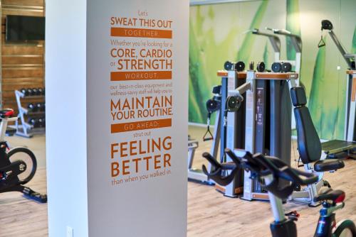 a sign in a gym with several exercise bikes at EVEN Hotel Miami - Airport by IHG in Miami