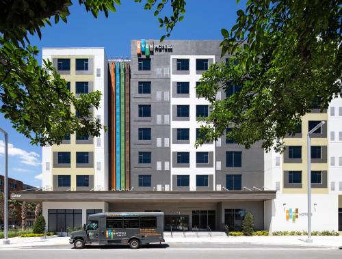 a bus parked in front of a building at EVEN Hotel Miami - Airport by IHG in Miami