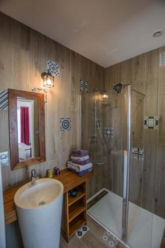 a bathroom with a shower and a sink and a tub at Les Cuves - Saintes in Chaniers