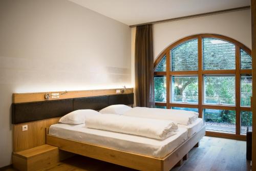 Ένα ή περισσότερα κρεβάτια σε δωμάτιο στο Hotel Ristorante Lewald
