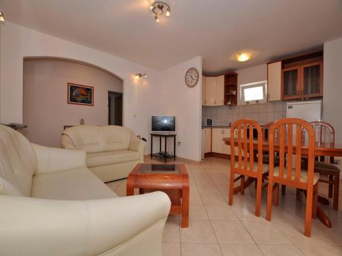 a living room with a couch and a table at Apartments Seagull in Postira