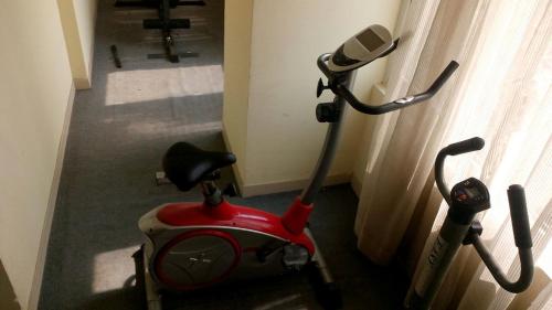 a red scooter parked in a room next to a window at Lords Plaza Ankleshwar in Ankleshwar