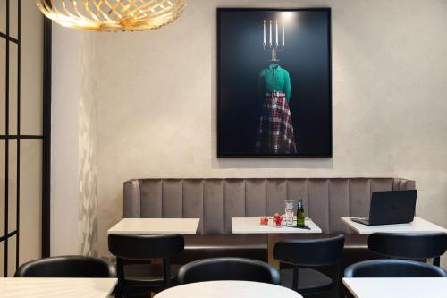 a dining room with a picture on the wall at Best Western Plus Hôtel Massena Nice in Nice