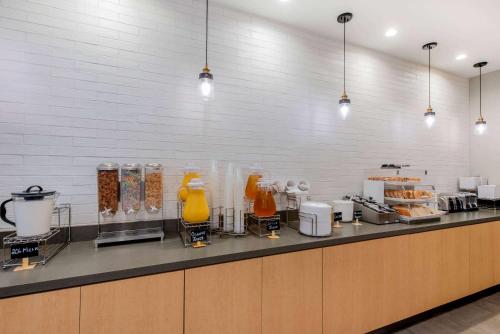 a kitchen with a counter with a bunch of food at La Quinta by Wyndham New Orleans Downtown in New Orleans