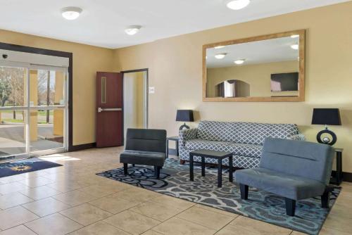 a living room with a couch and two chairs at La Quinta by Wyndham Morgan City in Morgan City
