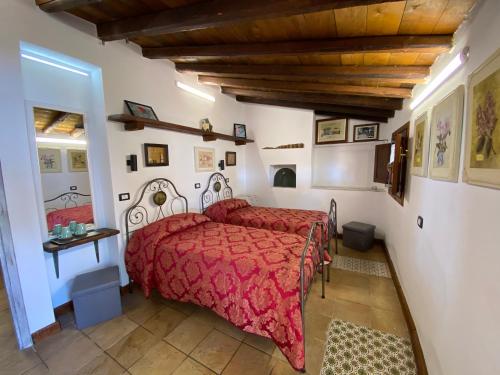 a bedroom with a red bed in a room at B&B Villa San Marco in Agrigento