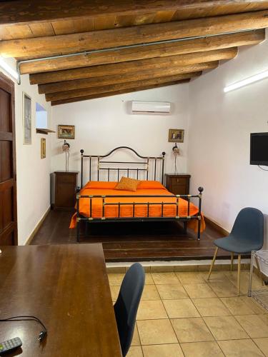 a bedroom with a bed and a table and chairs at B&B Villa San Marco in Agrigento