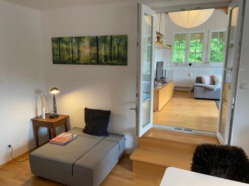 a living room with a couch and a chair in a room at Apartment am Wildbach - Radeln, Wandern, Natur, Urlaub mit Hund in Fischbachau