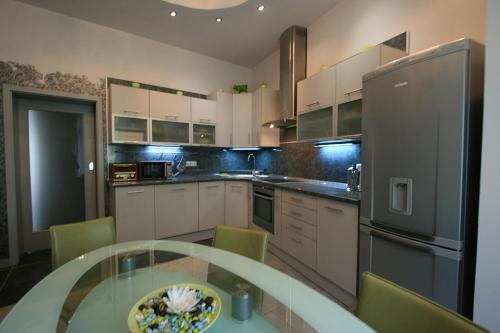 a kitchen with a table and a refrigerator at Apartment No 21 - I P Pavlova 34 in Karlovy Vary