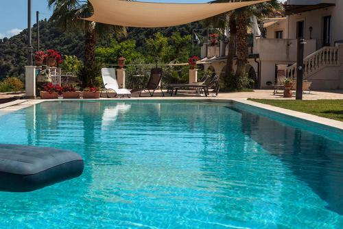 a swimming pool with blue water in a house at Tenuta Santa Tecla in Acireale