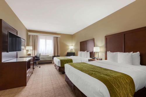 a hotel room with two beds and a flat screen tv at Comfort Inn & Suites Page at Lake Powell in Page
