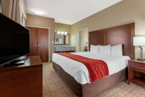 a hotel room with a large bed and a flat screen tv at Comfort Inn & Suites Page at Lake Powell in Page