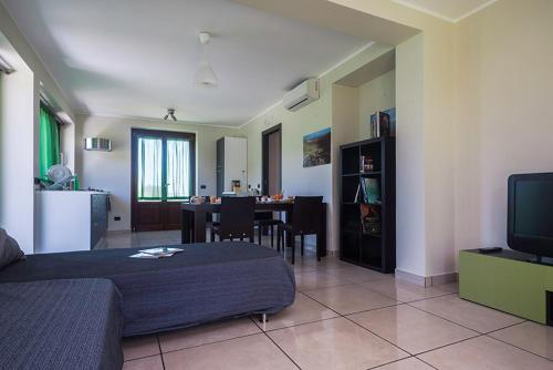 a living room with a bed and a dining room at Tenuta Santa Tecla in Acireale