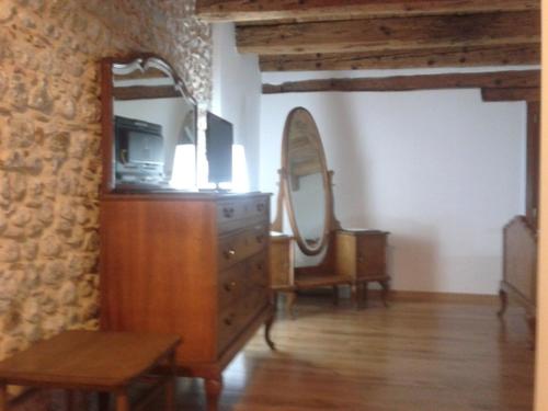 a room with a wooden dresser and a mirror at Alloggio Agrituristico Conte Ottelio in Pradamano