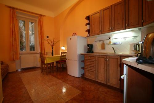 a kitchen with a white refrigerator and a table at Apartment No. 2 Tržiště 29 in Karlovy Vary