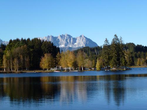 a large lake with a mountain in the background at Alpen Glück Hotel Kirchberger Hof in Kirchberg in Tirol