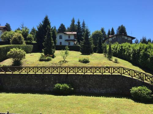 a bridge over a stone wall in a yard at Contessa Pace - Luxury flat in Selvino