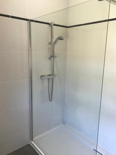 a shower in a bathroom with a glass door at The HopBarn in Hockerton