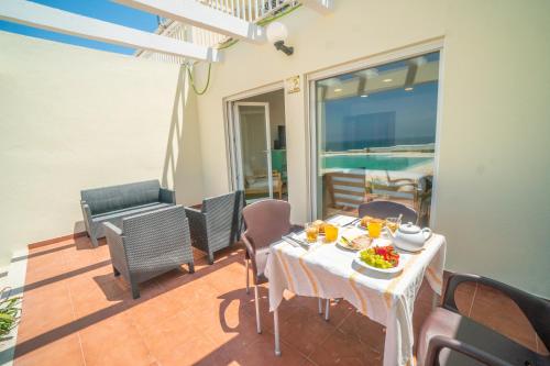 a table with a plate of food on a balcony at Casa da Azenha Terrace Prime in Santa Cruz