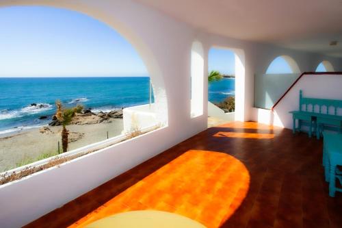 a living room with a view of the ocean at Hotel Patricia in Torreguadiaro