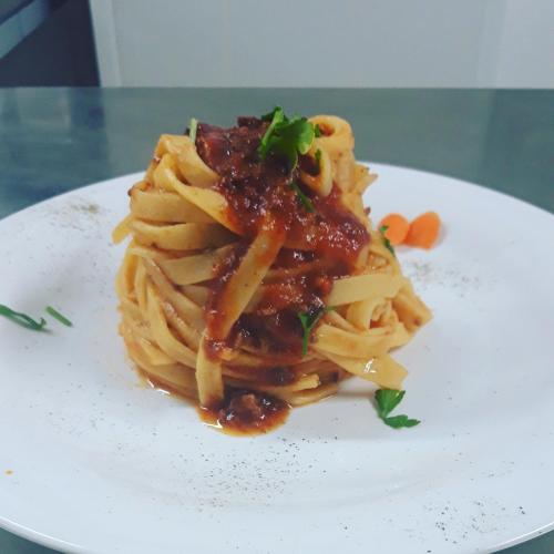 a plate of pasta with sauce on a table at Agriturismo Leanza "La Baita" in Cesarò