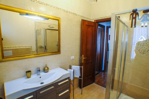 a bathroom with a sink and a shower and a mirror at I Love Pietra Ligure in Pietra Ligure