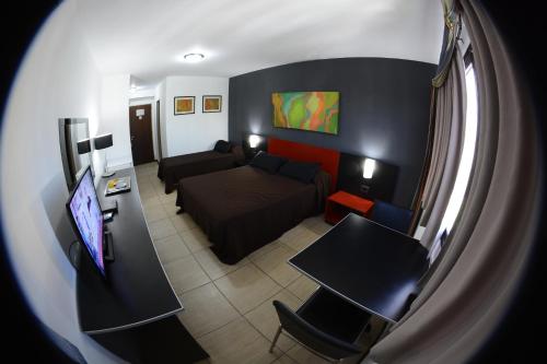 a living room with a couch and a table at Apart Hotel Alvear in Rosario