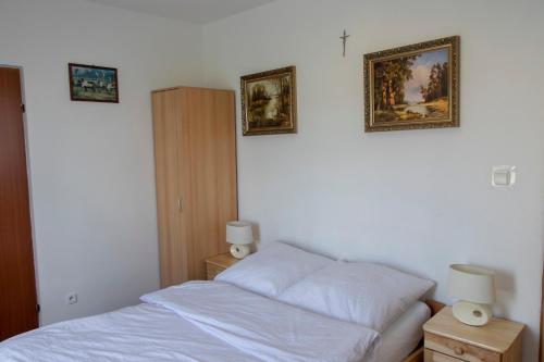 a bedroom with a bed and pictures on the wall at Noclegi u Banysia w sercu Gór Świętokrzyskich in Krajno Pierwsze