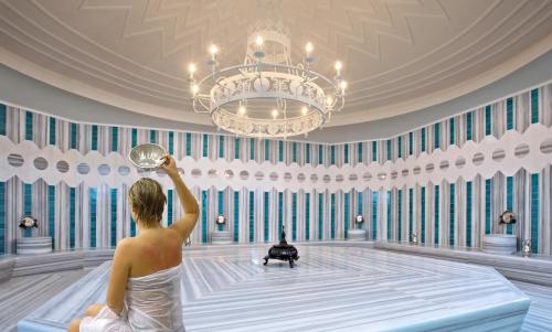 a woman is sitting in a bowling alley at Hillstone Bodrum Hotel & Spa in Bodrum City