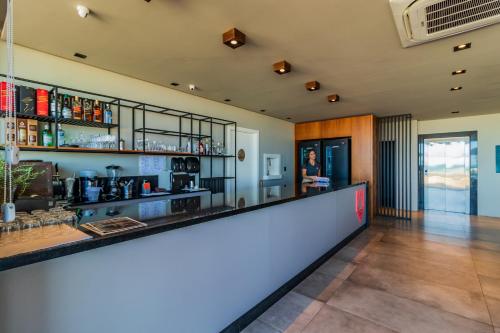 a bar in a room with a counter top at BALUARTE POUSADA in Torres