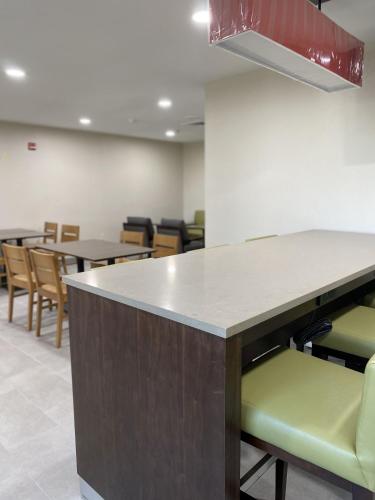 an empty waiting room with tables and chairs at Country Inn & Suites by Radisson, Fort Worth, TX in Fort Worth