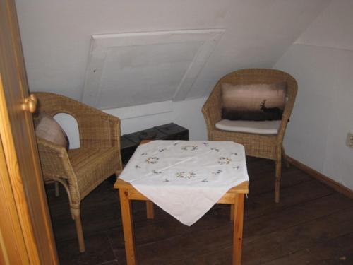 a small room with a table and two chairs at Ferienhaus Becker in Rödental
