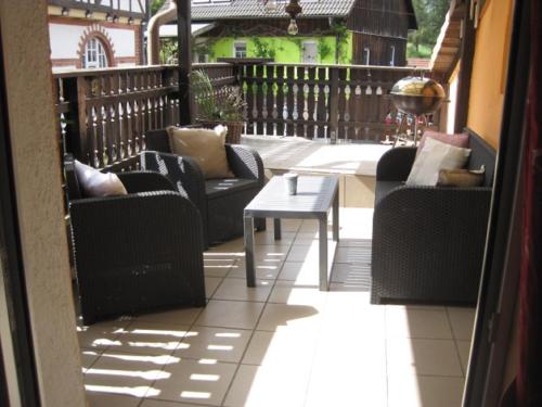 a patio with chairs and a table on a balcony at Ferienhaus Becker in Rödental