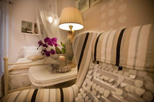 a room with a chair and a table with a lamp at Fisher House in Sopot