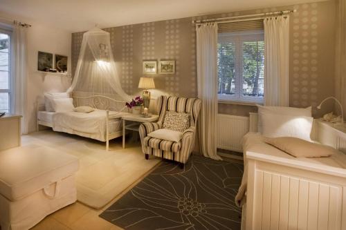 a bedroom with a bed and a chair and a couch at Fisher House in Sopot